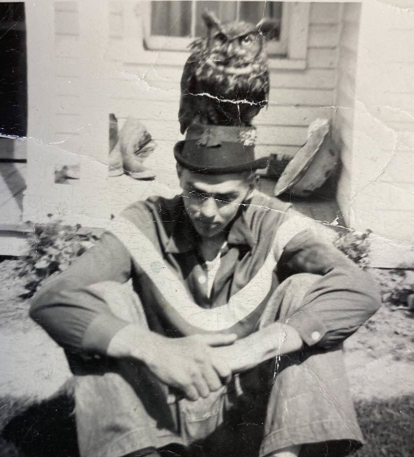 Milo’s son, John Smith, father of Michael, Jack Smith, Kathaleen Smith Ervin, and Michele Smith Mlinar | with a trained owl on his head at the Smith Brothers Farm