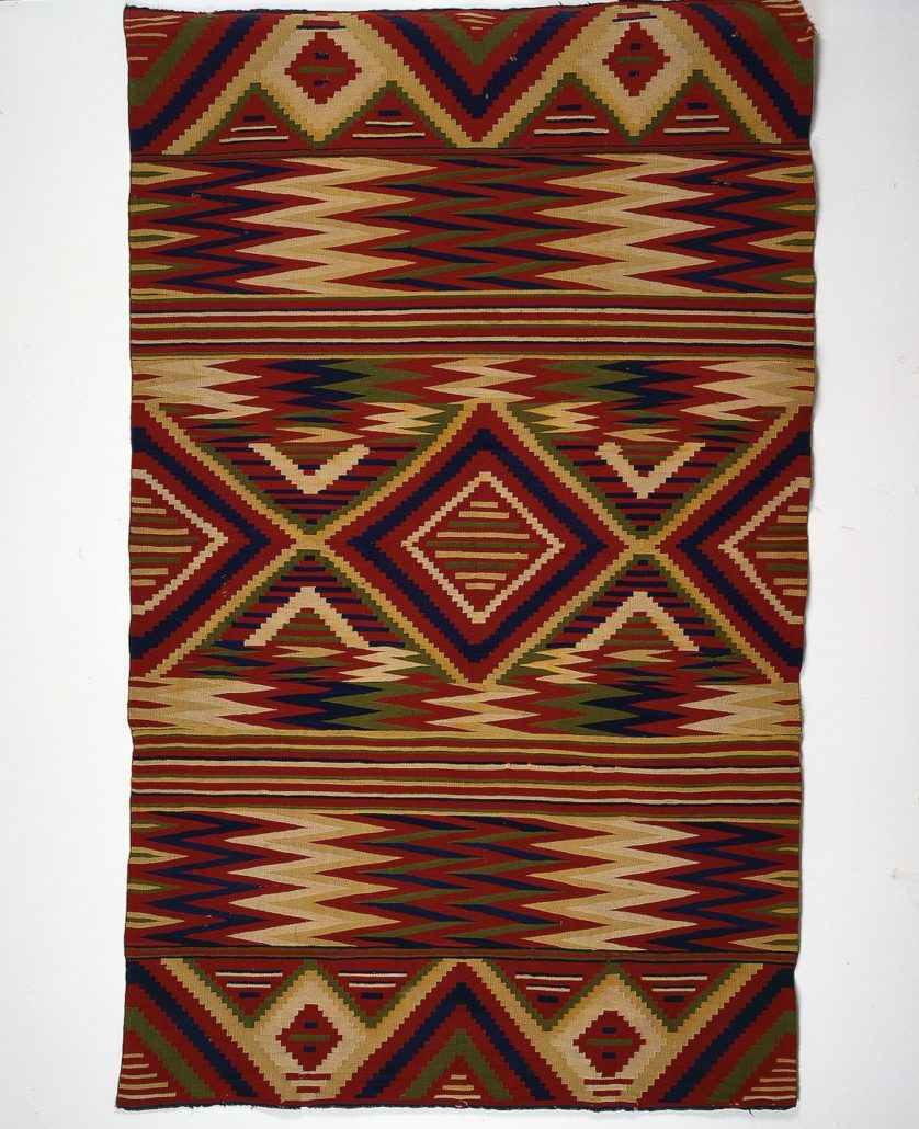 Diné (Navajo) artist, Serape, c. 1875-1885, Arizona. Handspun white and indigo-dyed blue, all other colors 4-ply synthetic-dyed Germantown, 52 × 90 in. Gift of Eugene V. and Clare E. Thaw, T0128. Photograph by Richard Walker.
