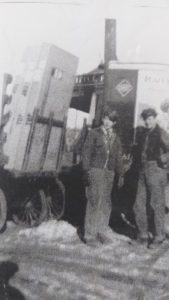 Employees Jimmy Fitzgerald (on right) and Al Munger loading Snyder’s bicycles onto railroad carts outside Little Falls train depot building. Photo courtesy of the Little Falls Historical Society.