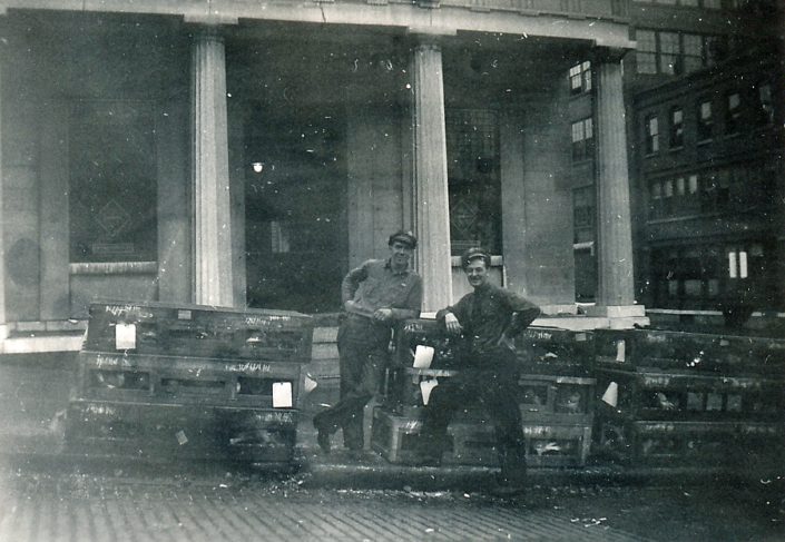 Railway Express Agency employees Al Munger (on left - Al later became Little Falls fire chief) and Jimmy Fitzgerald (on right) pictured with cages of homing pigeons outside of the company office once housed in the Old Bank Building. Photo courtesy of the Little Falls Historical Society.