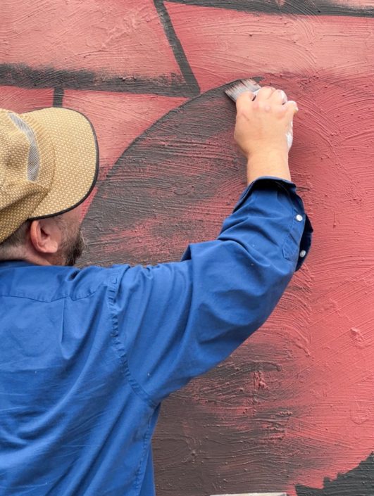 Justin Como as Lead Artist at the Stone Soup American Bistro and Beer Garden Mural Event. Justin Como as Lead Artist at the Stone Soup American Bistro and Beer Garden Mural Event.