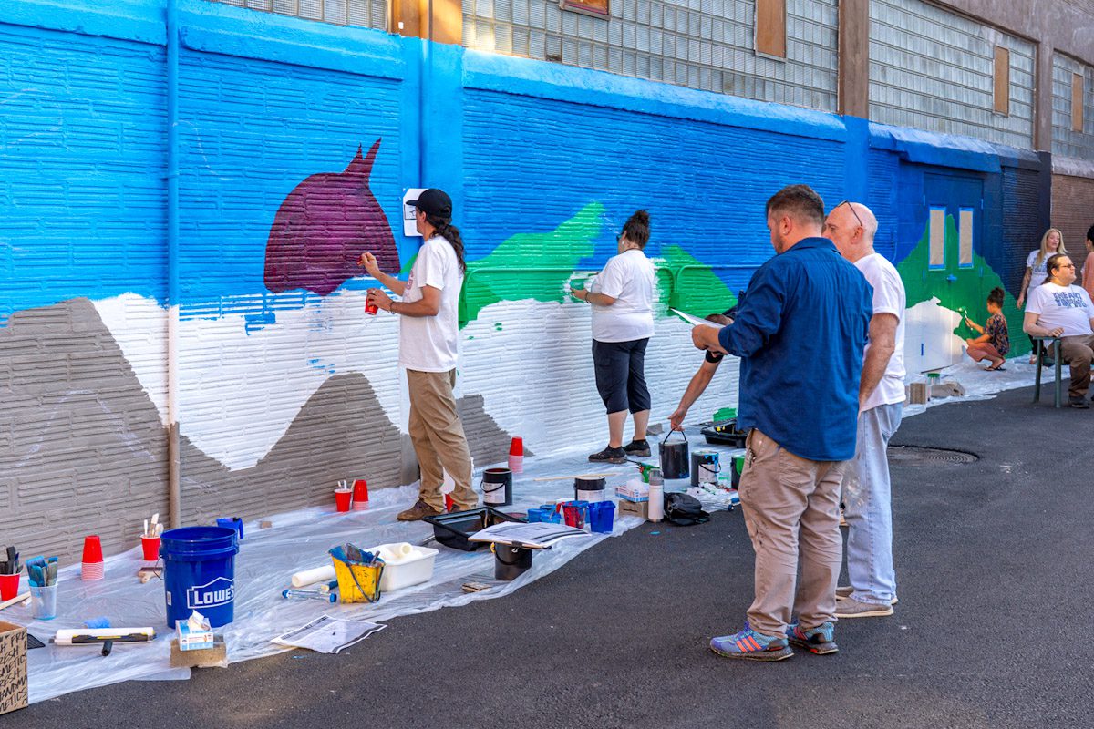 Featured Mohawk Valley Artist Daniel Marrone working with The Art Thing Collaborative on the mural at the Stone Soup American Bistro Beer Garden